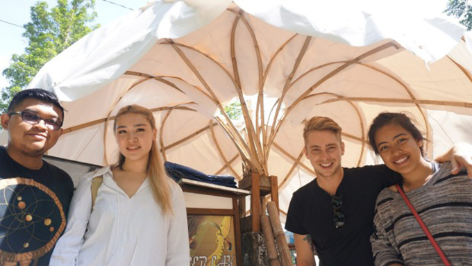 Architecture students Fauzan Alfi A, Stephanie Cheung, Laras Winarso and Matthew Hunter with a prototype of their street vendor shelter to be used in Indonesian cities. Image: Michael Neilson