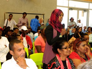 A young Somali woman asks a question at the African Youth Forum yesterday called to respond to a research report alleging NZ police are racially profiling young Africans. The tall man in the rear of the picture is Guled Mire, one of the organisers of the forum. Image: Del Abcede/PMC
