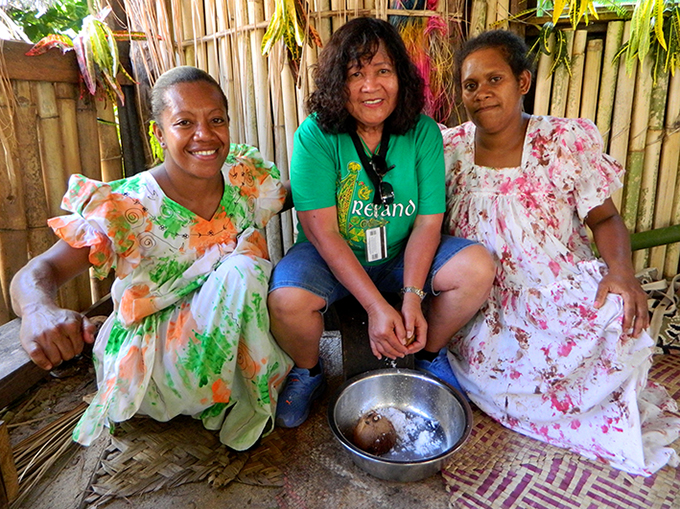 June Keitadi (left) and Del Abcede grating coconut on Aneityum Island on Christmas Day 2015. Photo by David Robie