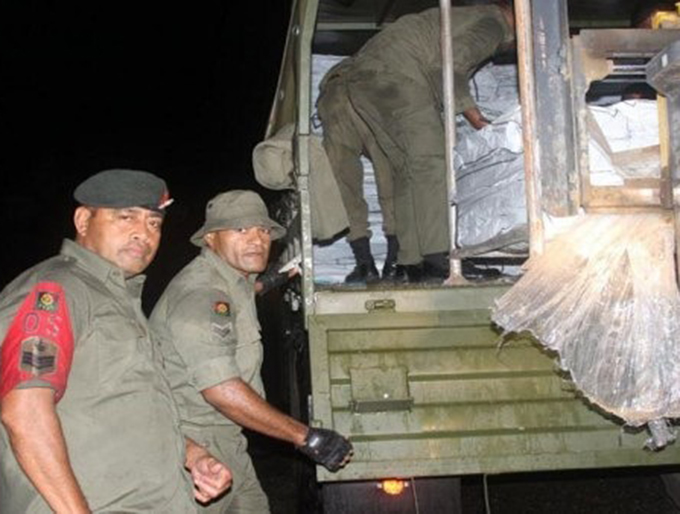 Republic of Fiji Military Forces and NDMO officials load emergency and relief supplies ready for deployment. Image: FijiGov 