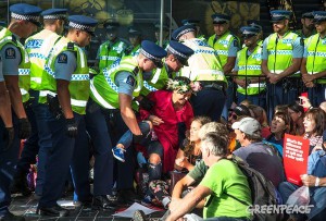 Police remove a climate action protester from in front of the oil industry conference at Auckland's Sky City. Image: Greenpeace Live Newsfeed