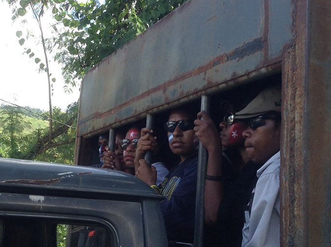 Arrested Papuan protesters behind bars on a police truck in Jayapura. Image: Tabloid Jubi