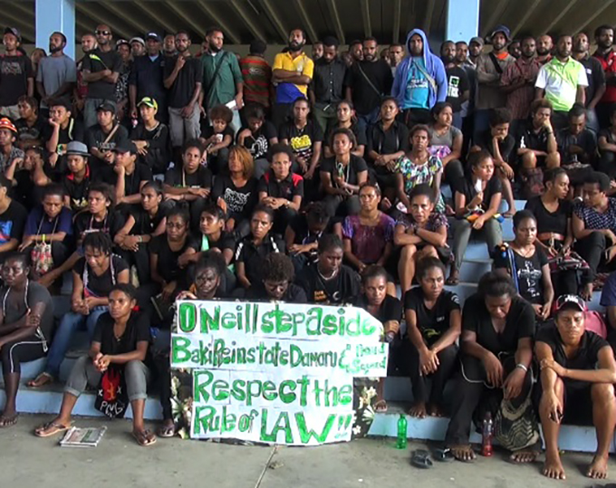 Students in the UPNG Forum with a message for Prime Minister Peter O'Neill at the height of the campus protests. Image: EMTV News