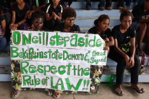 University of Papua New Guinea (UPNG) students holding a protest sign demanding the resignation of PM Peter O'Neill. Image: Supplied