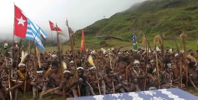West Papuans raising the banned Morning Star flag in defiance of Indonesian authorities in Yahukimo in the Highlands last Thursday. Image: Benny Wenda