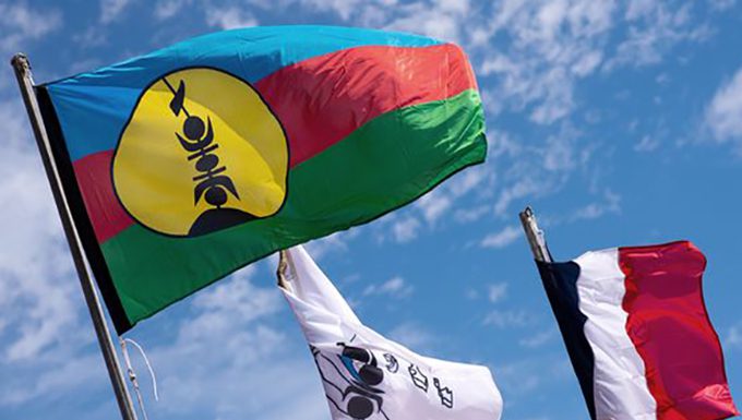 New Caledonia referendum offers chance to turn page, says journo Kanak and French flags