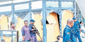 Police guard looted shop