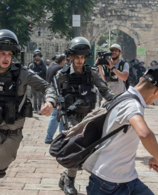 sraeli police chase a Palestinian demonstrator
