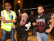 People helping an injured Palestinian woman