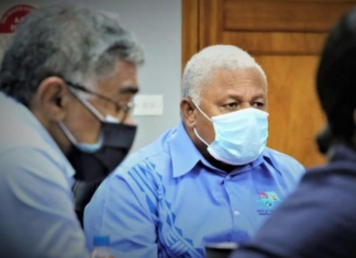 Fiji's Health Secretary Dr James Fong (left) and Prime Minister Voreqe Bainimarama