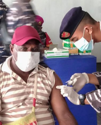 A Papuan man being vaccinated at Sorong, West Papua