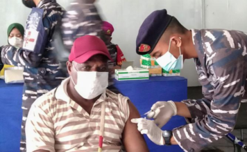 A Papuan man being vaccinated at Sorong, West Papua