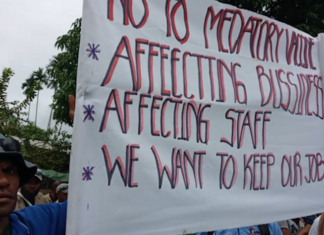 Lae workers protest against covid jab