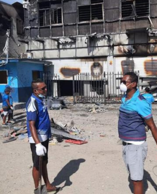 Fijian community help Bank of South Pacific staff clean up in Honiara