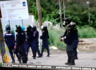 Armed police with teargas masks on guard in Honiara