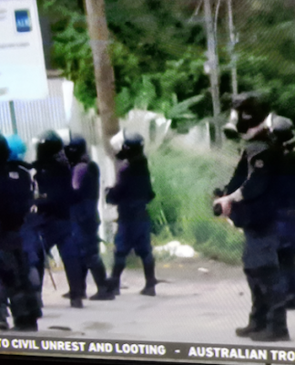 Armed police with teargas masks on guard in Honiara