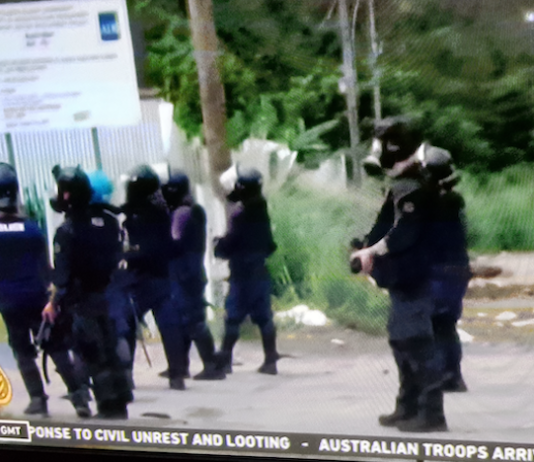 Armed police with teargas masks on guard in Honiara