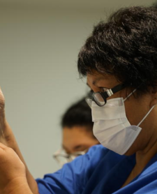 A NZ vaccinator prepares a covid-19 vaccination