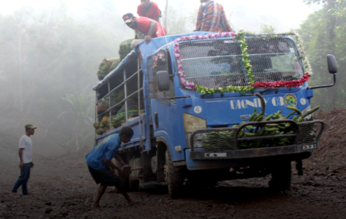 A woman puts a rock under the "Dignity" PMV wheel