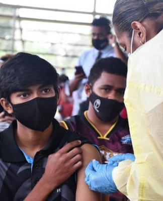 Teenagers receive their jabs in Fiji