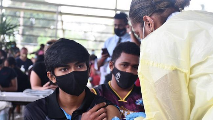 Teenagers receive their jabs in Fiji