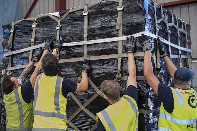 NZ Defence Force staff stack disaster relief supplies for Tonga