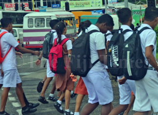 Fiji students walk to a secondary school in Suva