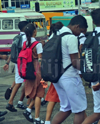 Fiji students walk to a secondary school in Suva