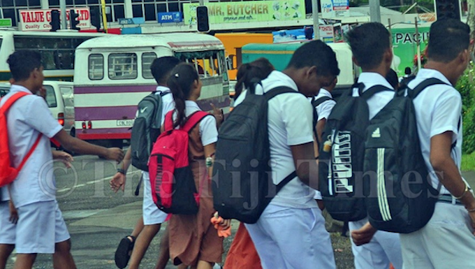 Fiji students walk to a secondary school in Suva