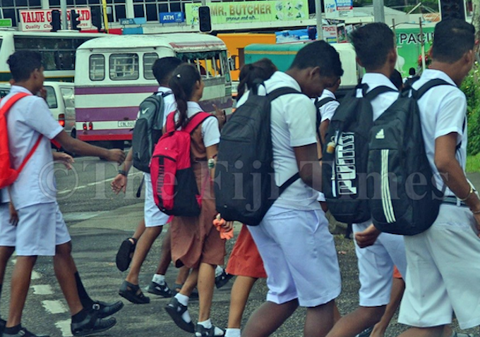 Fiji students walk to a secondary school in Suva