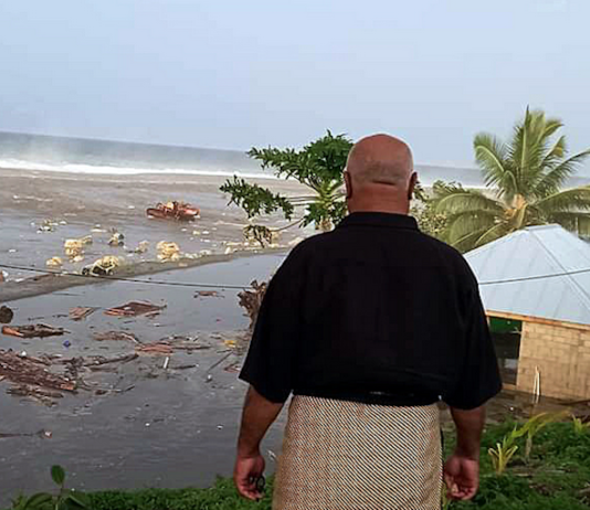 tsunami wave crashes into a Tongan house