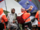 A Pacific protester blows a conch shell horn at the anti-mandate occupation atNZ Parliament