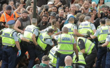 Police clearing away the protesters in Parliament grounds