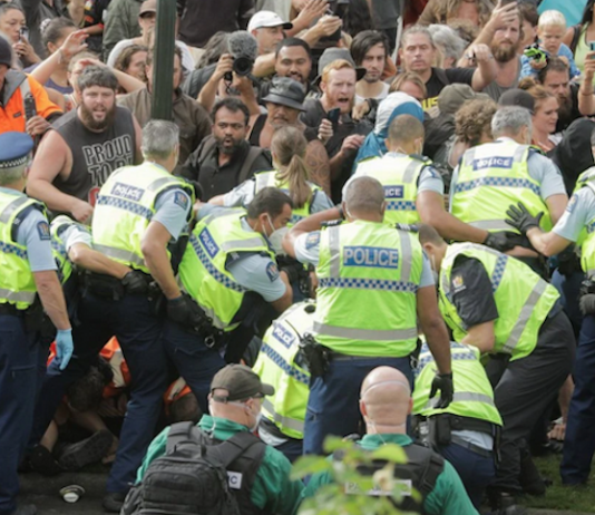 Police clearing away the protesters in Parliament grounds