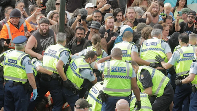 Police clearing away the protesters in Parliament grounds
