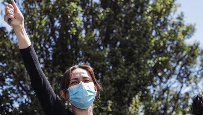 Protestor Lana shouts out to the crowd by the Russian Embassy