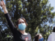 Protestor Lana shouts out to the crowd by the Russian Embassy