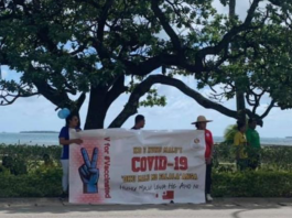 A #VForVaccinated banner in Tonga