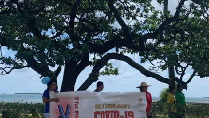 A #VForVaccinated banner in Tonga