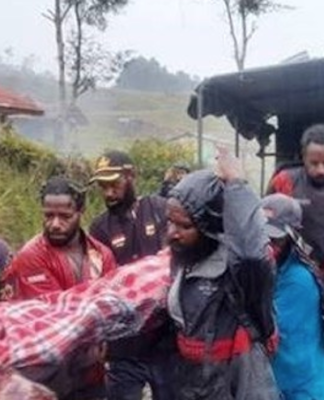 Relatives carry body of a 12-year-old Papuan boy