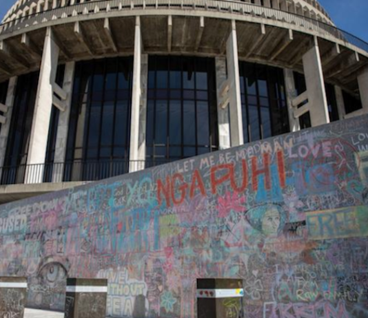 Wall graffiti chalked up by anti-mandates protesters
