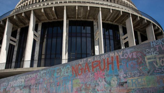 Wall graffiti chalked up by anti-mandates protesters