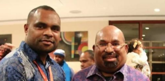 Papuan student Laurens Ikinia (left) with Governor Lukas Enembe