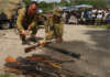 Members of RAMSI military destroy surrendered weapons