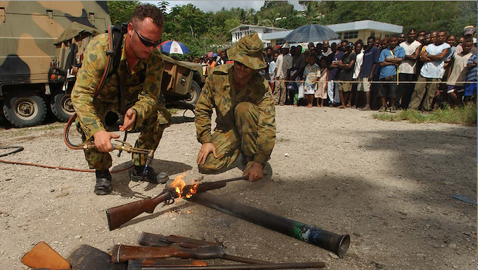 Members of RAMSI military destroy surrendered weapons