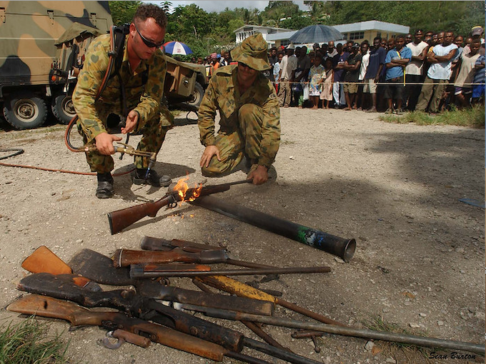 Members of RAMSI military destroy surrendered weapons
