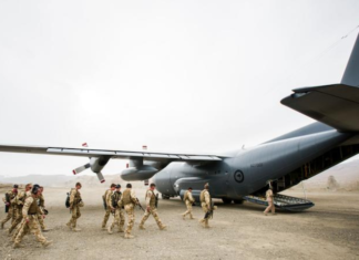 NZ Defence Force personnel boarding a Hercules plane.