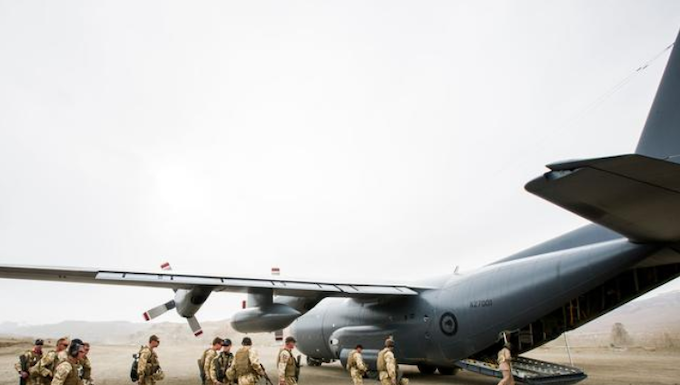 NZ Defence Force personnel boarding a Hercules plane.