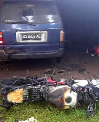 The burnt out motorbike in front of Papua LBH office