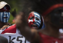 Papuan students, with their body and face painted with the colours of the banned Morning Star flag